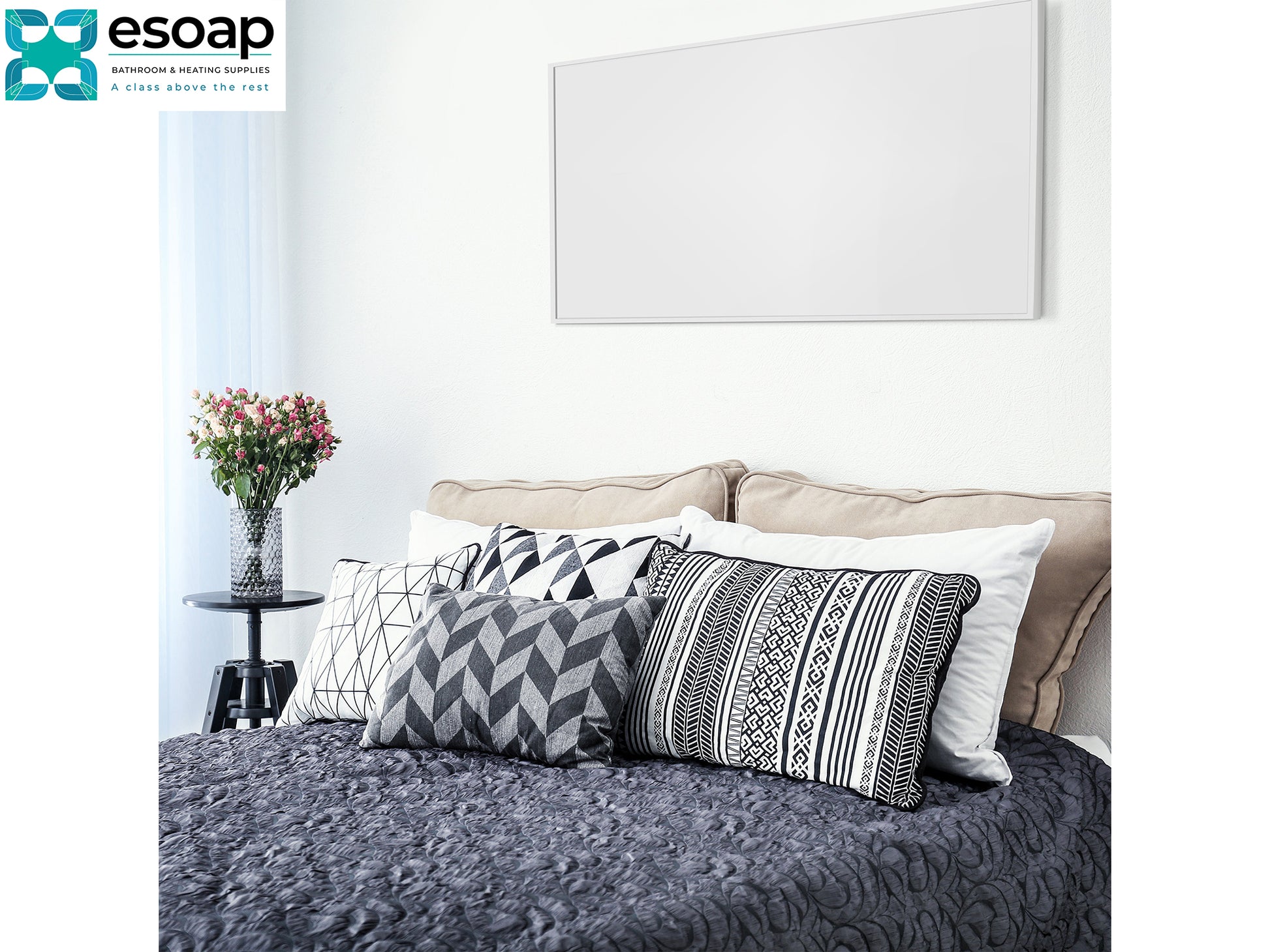 Decorative pillows on a bed with a 'esoap' logo in the corner and wall hanging 700W Classic Infrared Heating Panel Black
