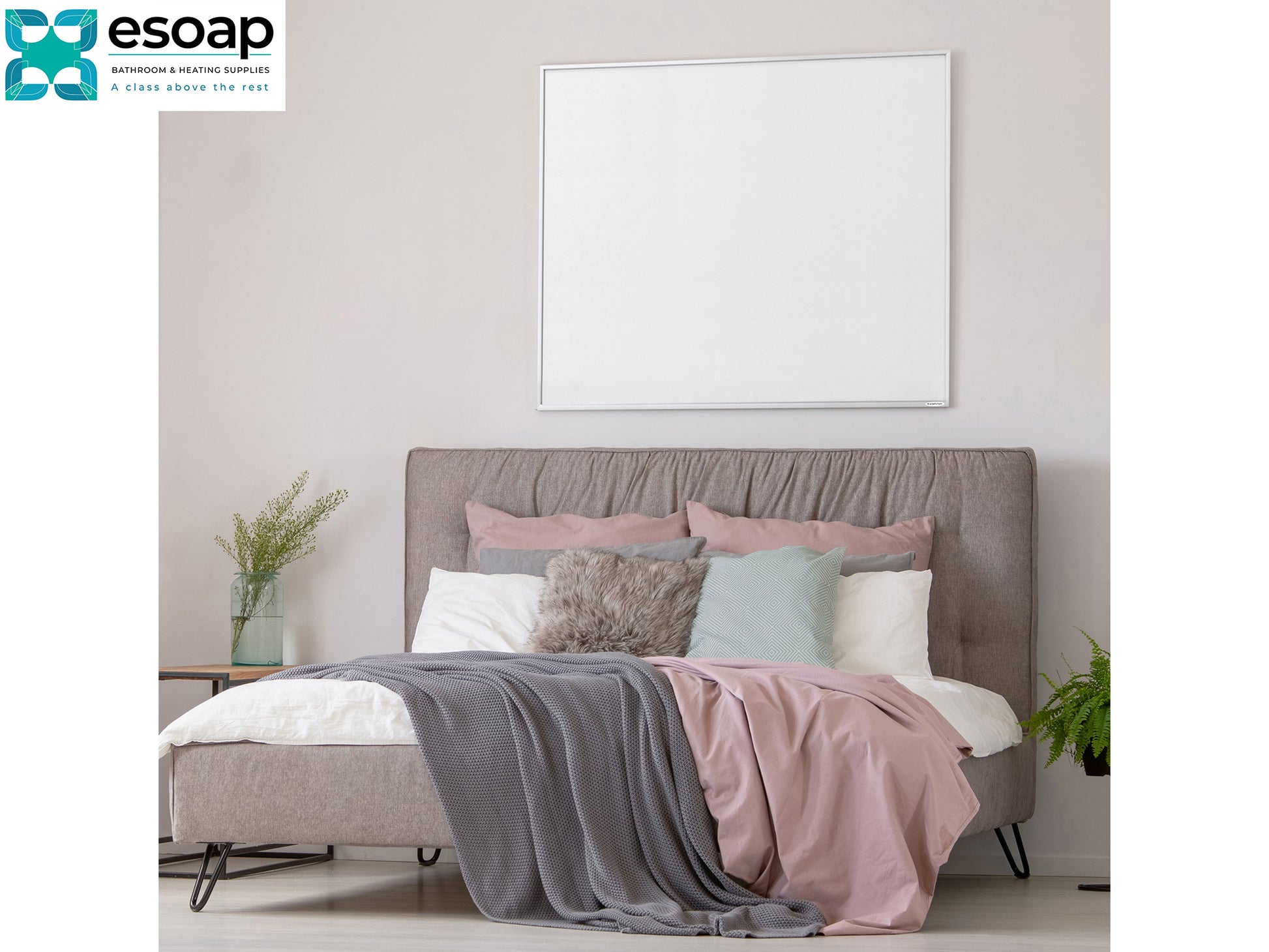 Bedroom with a bed featuring gray, pink, and white bedding, and 'esoap' logo with 1200W NXT Gen Infrared Heating Panel on wall