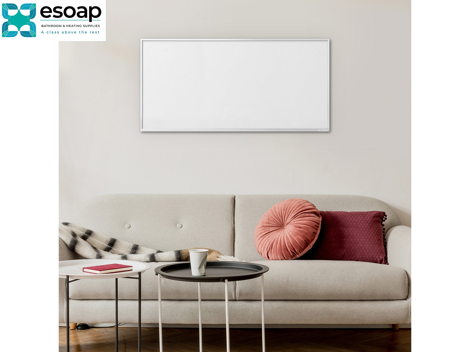 Living room with a beige sofa, coffee table, and decorative pillows, featuring the Esoap logo with 700W NXT Gen Infrared Heating Panel on wall