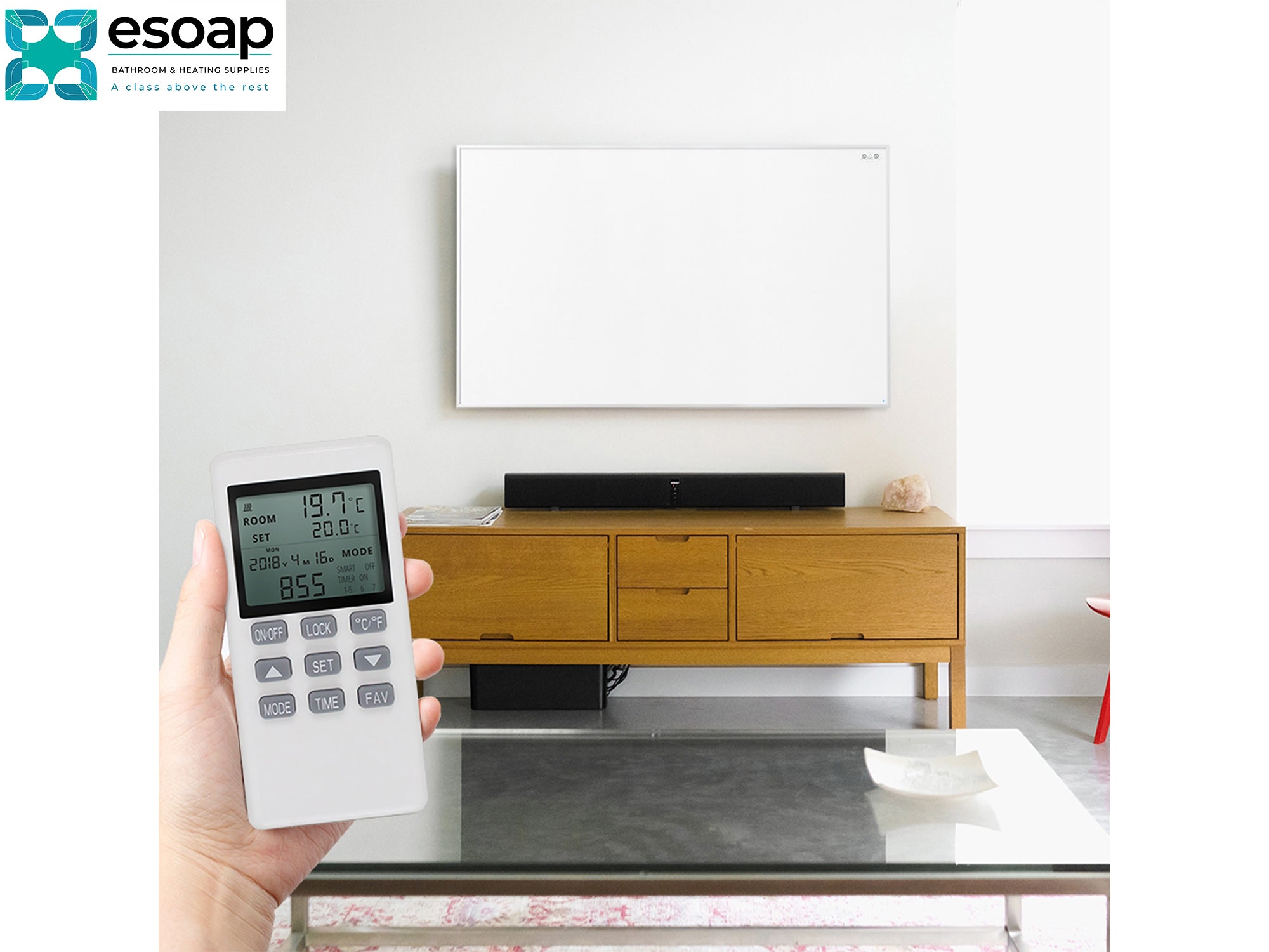 Hand holding a remote control with a smart home device in a living room setting, featuring the Esoap logofor 900W NXT Gen Infrared Heating Panel on wall