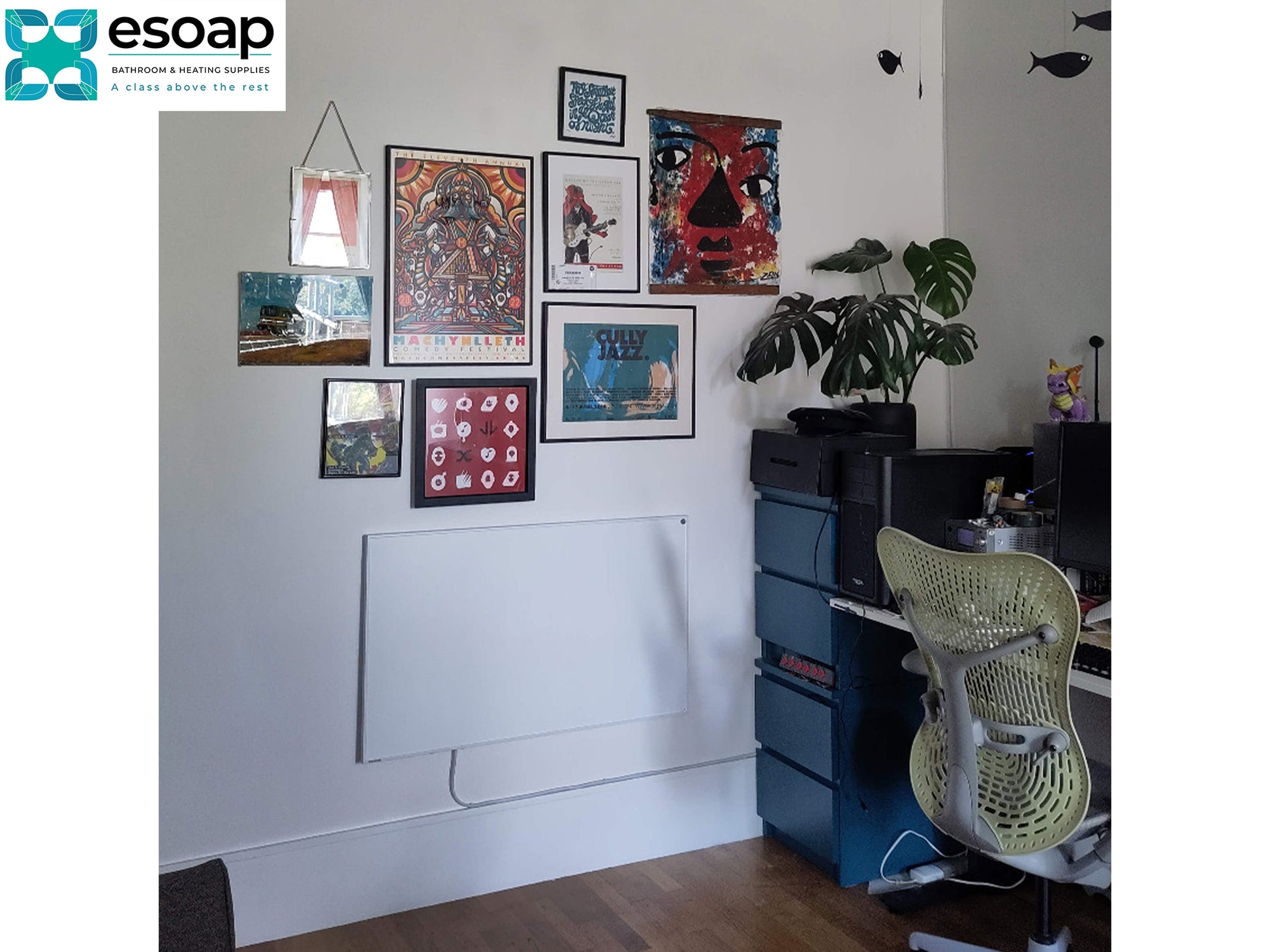 Home office with framed posters on the wall, a desk, and chair and wall hanging 700W Classic Infrared Heating Panel Black