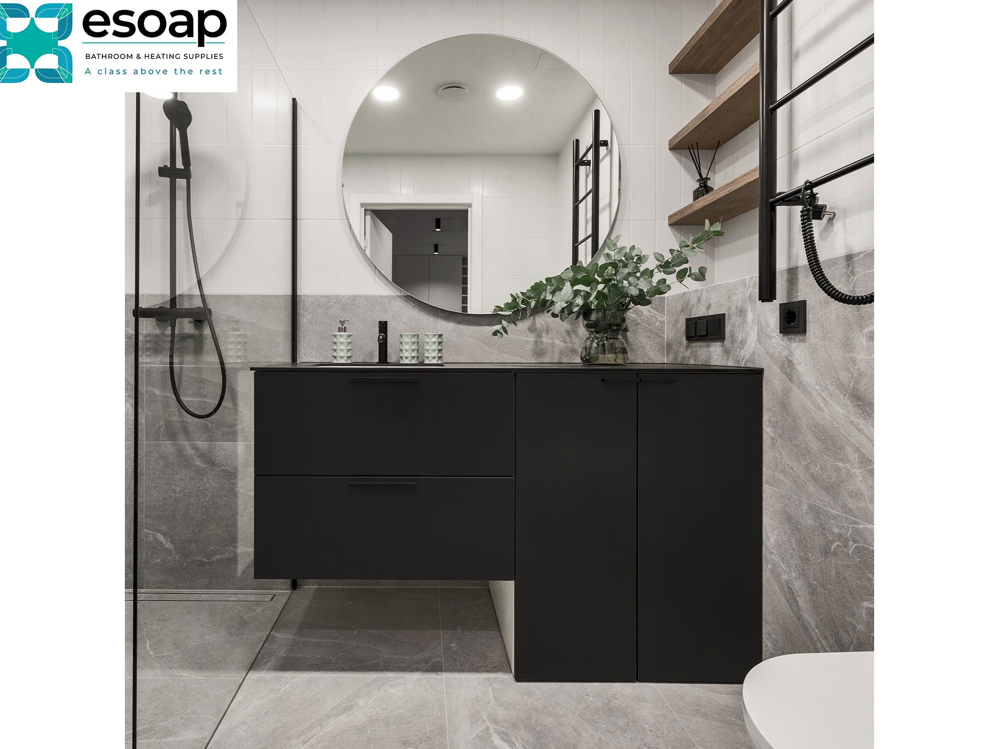 Modern bathroom with black vanity and marble walls, featuring Esoap logo with 320W Round Mirrored Wi-Fi Infrared Heating Panel