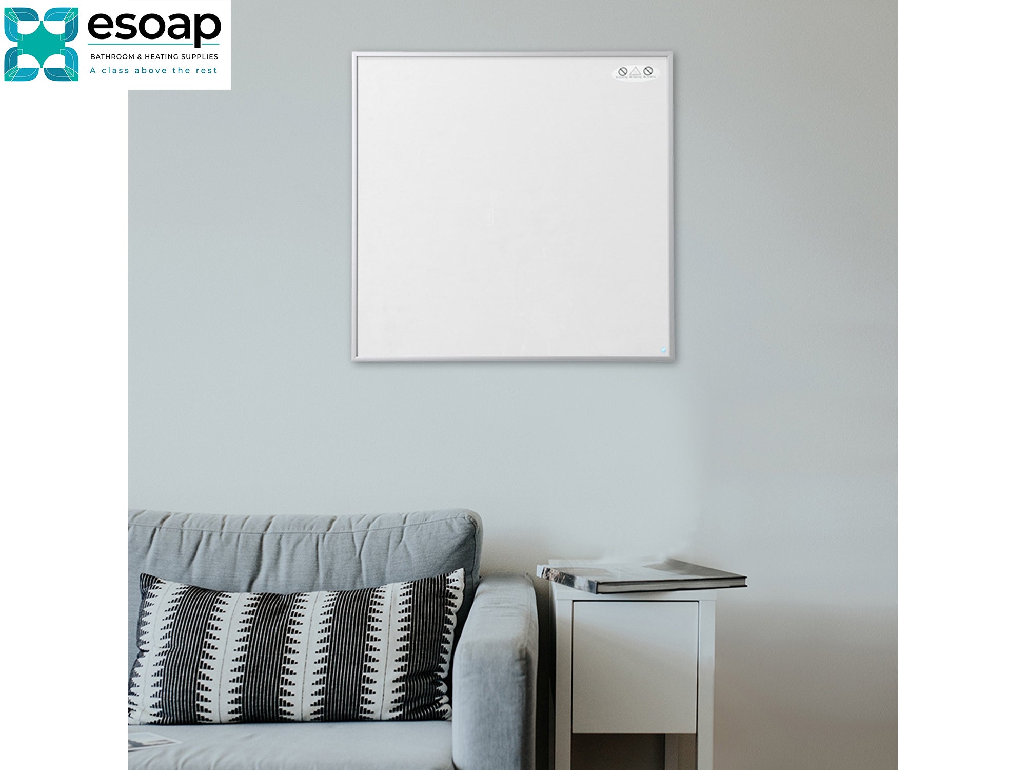 350W NXT Gen Infrared Heating Panel on a gray wall above a sofa with a pillow.